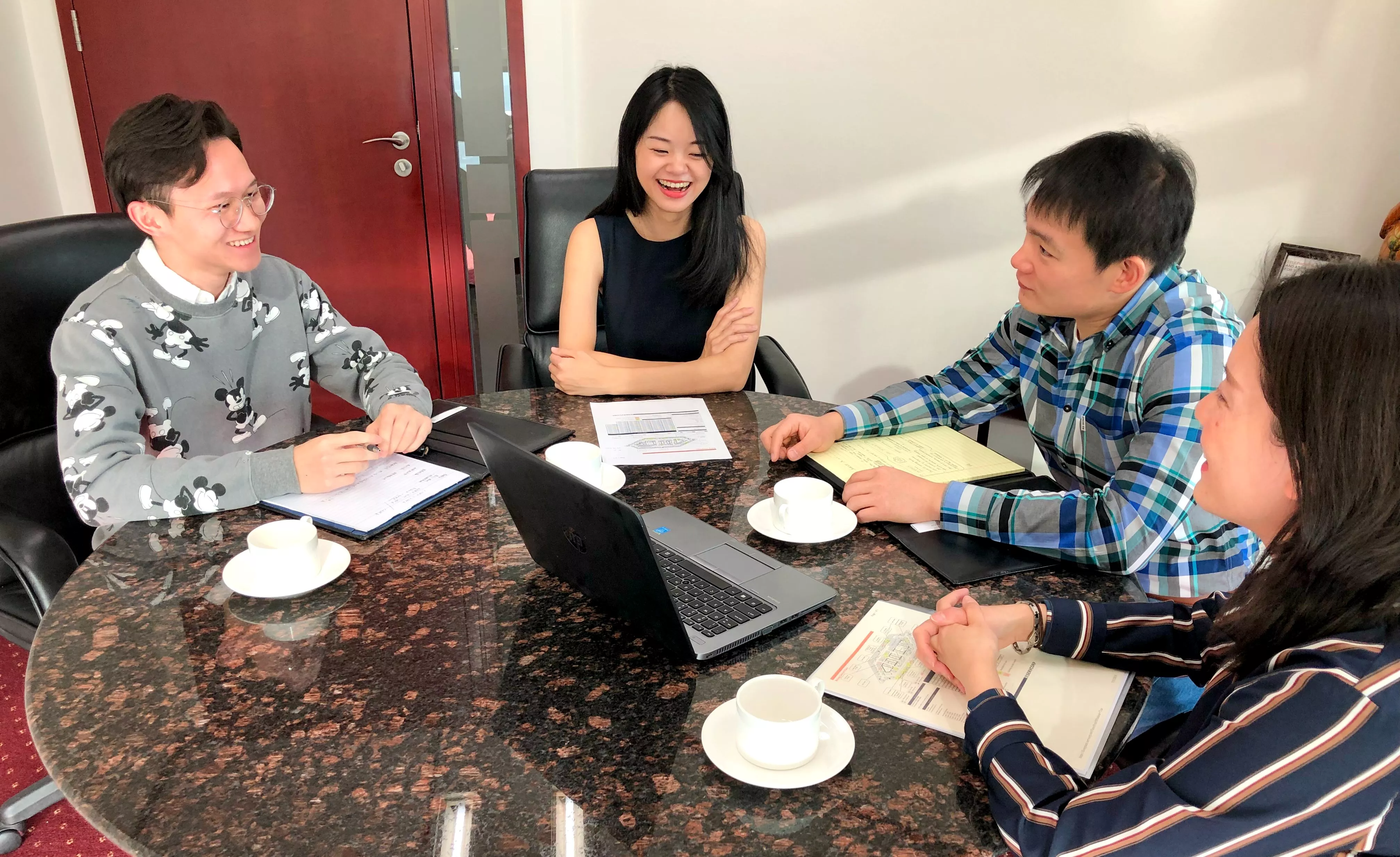 Clients receiving IT related help in a modern meeting room space